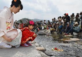 Paper-made "hina" dolls floated on river