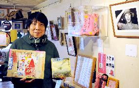 Imawano fan poses with artworks at Harajuku cafe