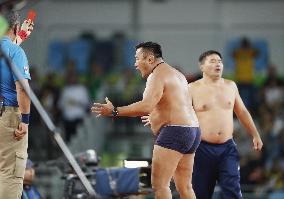 Olympics: Mongolian wrestling coaches strip in protest