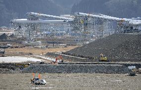 Giant conveyors in operation on site bulldozed after 2011 tsunami