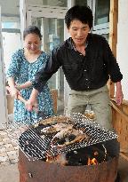 Tourist experiences bonito cooking in Kagoshima Pref.
