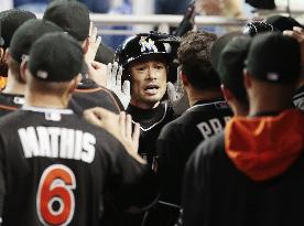 Ichiro welcomed by teammates after touching home plate
