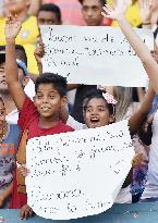 Young supporters cheer for Brazil soccer team