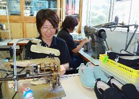 Tokutake Sangyo workers make "Ayumi" shoes for seniors