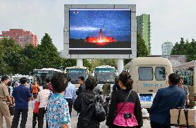 North Koreans watch news of their country's missile launch
