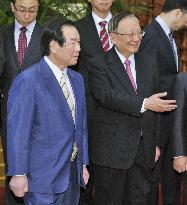 Japan's ex-finance chief meets China's ex-foreign minister in Beijing