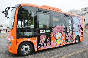Bus with mascot images promotes Japan's oldest reservoir