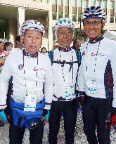 3 cyclists pose after completing Seoul-Tokyo journey