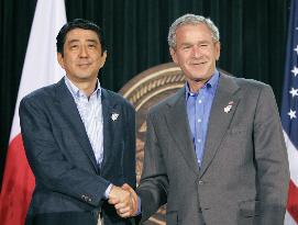 Abe, Bush warn N. Korea of tougher action