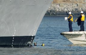 Coast Guard divers examine destroyer involved in collision