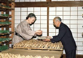 Empress Michiko helps silkworms produce cocoons