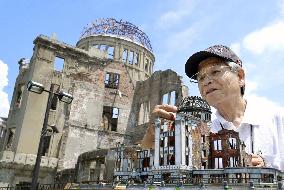 Tour guide using self-made models of Hiroshima bomb site