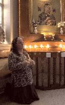 Christian woman prays in Baghdad