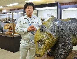 Curator explains carved wooden bears at museum in their birthplace