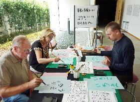 Tourists experience calligraphy at Nara museum