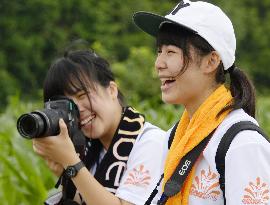 High school students smile while taking photos for national contest