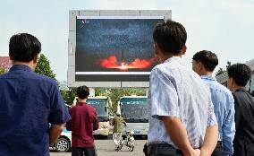 North Koreans watch news of their country's missile launch