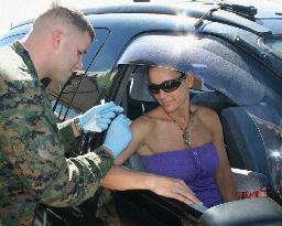 Families of U.S. Marines get flu vaccine shots at drive-thru stat