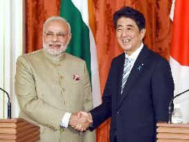 Indian PM Modi shakes hands with Japanese PM Abe