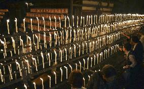 Well-wishers light candles at shrine in western Japan