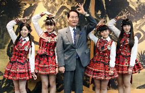 Kagawa Gov. Hamada poses with AKB48 members