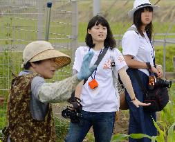 Students listen to farmer while photographing for national contest