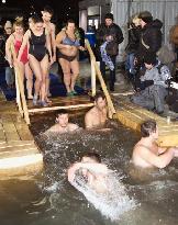Orthodox Christians soak in icy water to mark Epiphany
