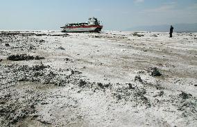 Boat abandoned on bed of dried-up portion of Iran's Lake Urmia