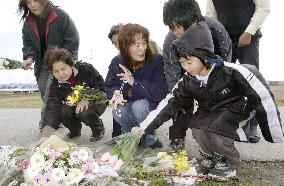 People offer flowers for victimized kindergartners