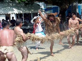 Man cuts rope during harvest festival on Amami-Oshima