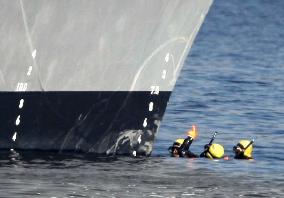 Coast Guard divers examine destroyer involved in collision