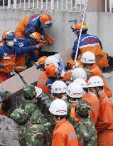 Japanese relief team continues to look for signs of life