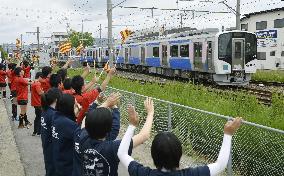 High schoolers wave to train on new railway line in northern Japan