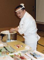 Sushi chef demonstrates to pitch "Global Sushi Challenge" event