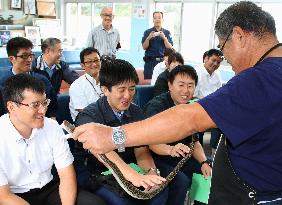 New police officers learn about fanged snake in southwest Japan