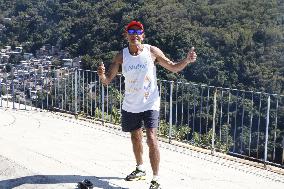 Olympics: Olympic torchbearer king of hill at Copacabana Beach