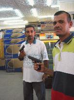 Armed employees patrol Iraqi stores