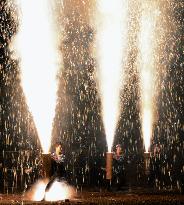 Men hold tubes for fireworks display during central Japan festival