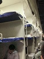 Travelers rest aboard sleeper train in China