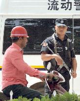 Police officer stands guard in China's Xinjiang Uyghur region