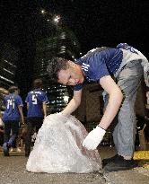 Football: World Cup fans collect trash after match