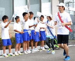 Ex-Olympic athletes run for relay in disaster-hit northern Japan