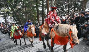 Horse riders ascend steps of Hokkaido shrine