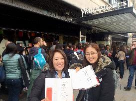 Women show off Haruki Murakami's autograph in London