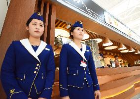 Female airport staffers on duty in new terminal building in Pyongyang