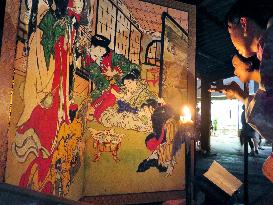 People view folding screen painting at west Japan summer festival