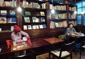 Customers relax at Nara cafe full of picture books