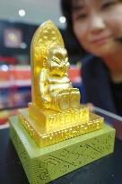 Gold figure of charm doll Billiken for sale in Osaka