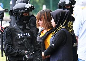 Malaysia charges 2 women with murder in Kim's death