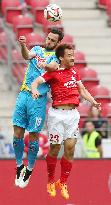 Mainz's Japanese forward Okazaki fights for ball against Cologne